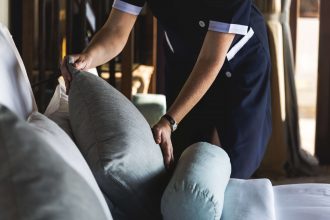 domestic lady tidying pillows