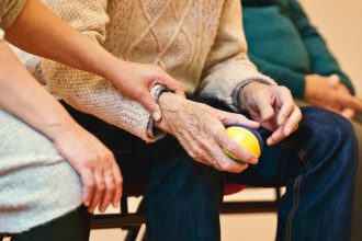 elderly woman holding a ball