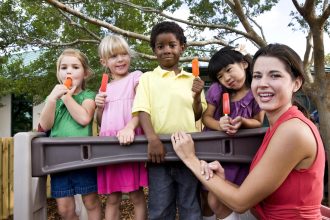 children and women holding ice lollies