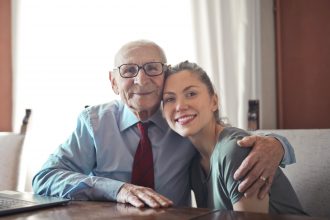 elderly man hugging daughter