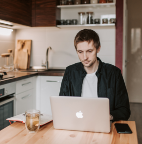 man on laptop at table